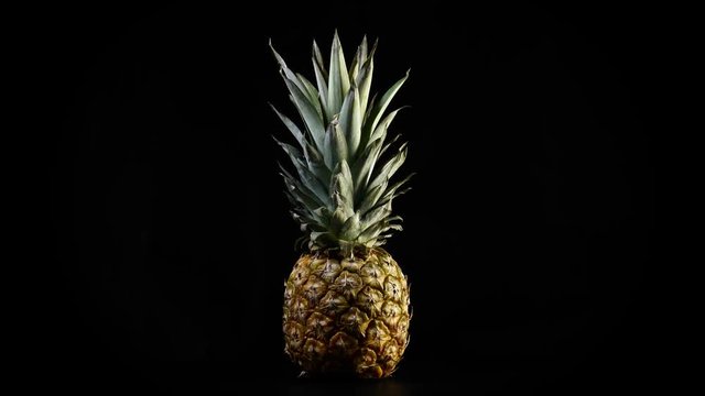 Pineapple rotating on black background