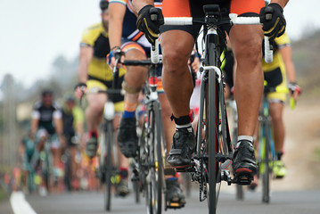 Plakat Cycling competition,cyclist athletes riding a race,detail cycling shoes