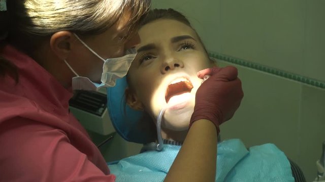 young girl treats her teeth