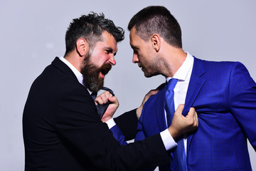 Coworkers decide upon best working position. Businessmen with angry faces