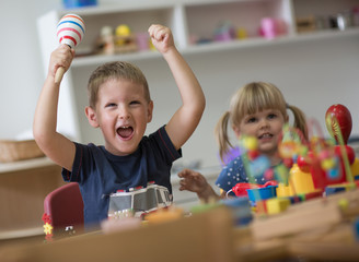 Smiling brother and sister in kindergarten