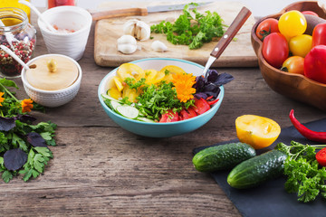  vegetarian salad with flowers on wooden table