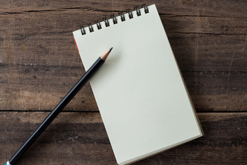 Kraft notebook clean and blank diary with pencil  on rustic wood  background. 