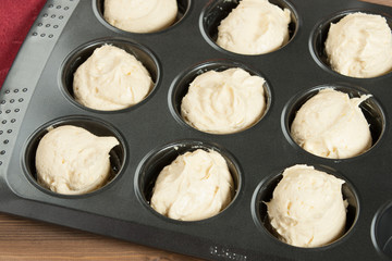 Raw Dough In Baking Tray. Cooking Process Of Homebaked Upside Down Clementine Muffins.