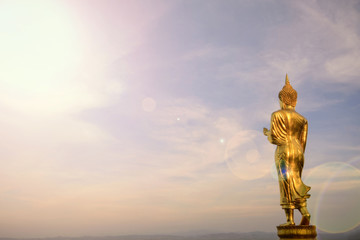 Fototapeta na wymiar Wat Phra That Khao Noi,View point,Golden Buddha statue standing on a mountainand lens fare,Nan, Thailand,