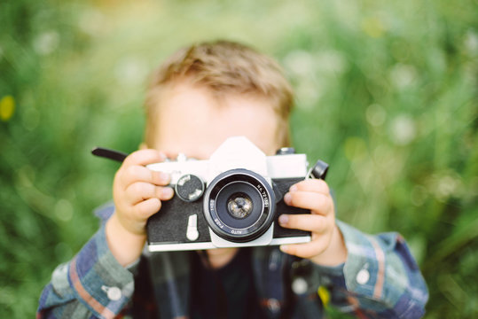 Child with an analog camera