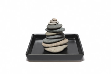 Stacked Stones Inside The Black Plate, Isolated On White Background