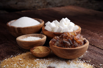 Fototapeta premium Various types of sugar, brown sugar and white on wooden table