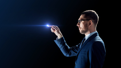 businessman in glasses with laser light over black