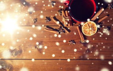 tea cup with winter spices on wooden table