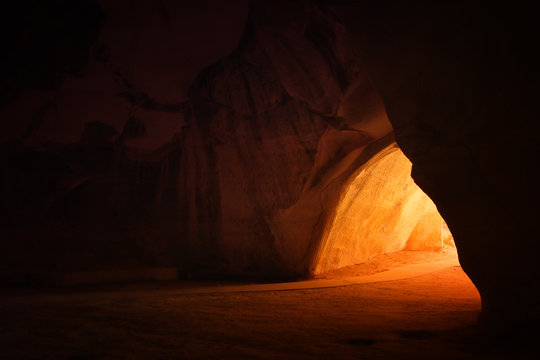 Fototapeta obraz pięknego złotego światła przez wejście do jaskini