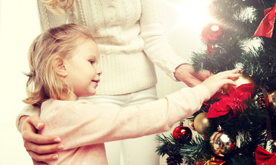 happy family decorating christmas tree at home