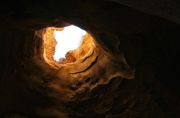 image of beautiful golden light through the cave entrance