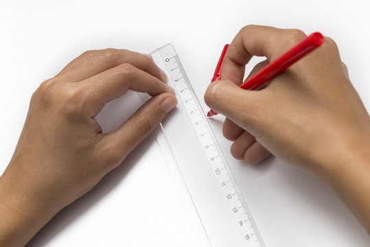 Hands Drawing A Line Using Ruler, Isolated On White Background