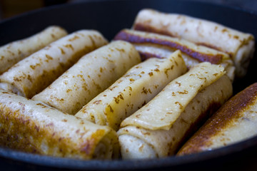 twisted pancakes in the pan