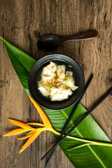 Shrimp wonton with braised pork in soup on wooden table - Asian food style  / Select focus image