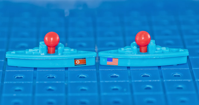 A collision on a toy Board battleship North Korean and USA warships with missiles