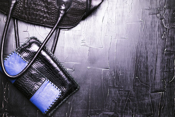 Black leather bag and a black bag on a black background.