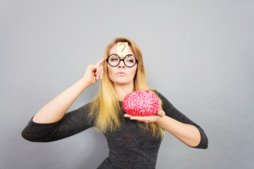 Weird woman holding brain having idea