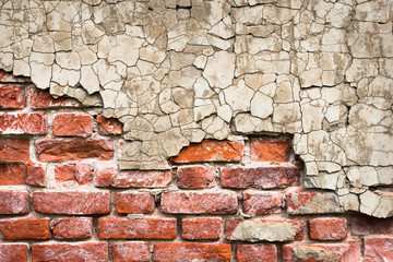 Brick wall with peeling plaster