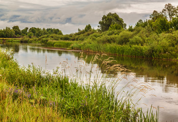 Cloudy evening on the river in Polissya