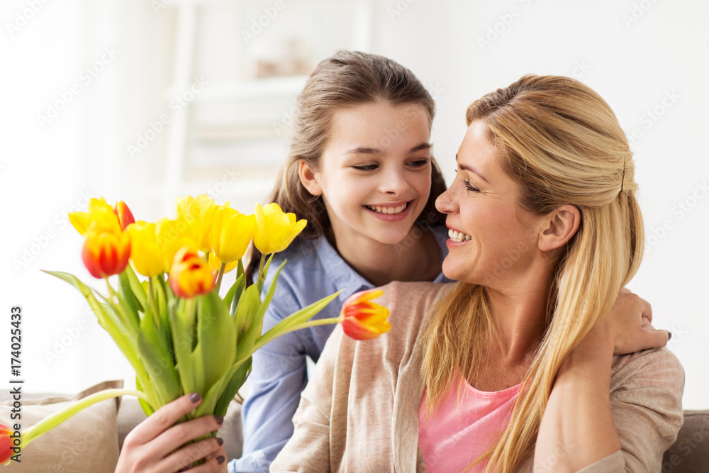 Poster happy girl giving flowers to mother at home