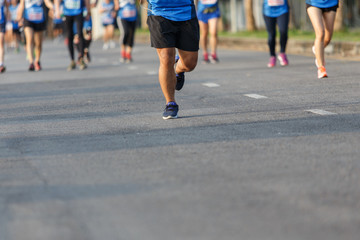 Marathon runners focus clear running shoes on the street.