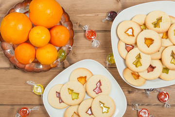 Home Baked Crystal Cookies On White Plates. Oranges, Clementines.