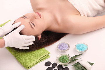 Obraz na płótnie Canvas Beautiful Young Woman Getting a Face Treatment at Beauty Salon.