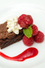 Chocolate Berry Brownie with Chocolate sauce on white dish, close up