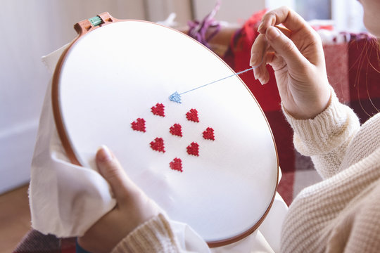Close-up of woman's hands doing embroidery.