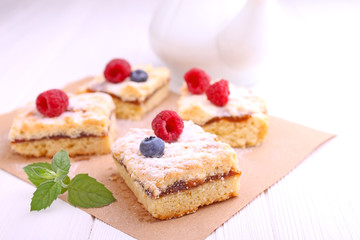 Obraz na płótnie Canvas Homemade pie with berries cut into slices on a white background