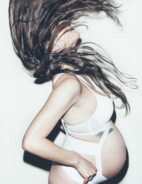 Pregnant Woman Wearing Lingerie and Belly Band