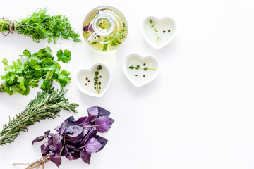 natural oil and fresh greenery for restaurant cooking on white kitchen table background top view space for text