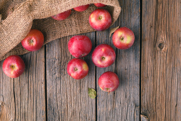 Heap of red apples in bulrap bag