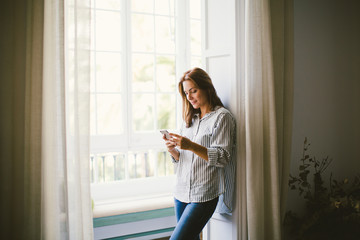 Woman chatting on phone at home.