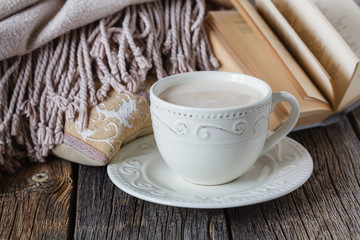 Fall evening with warm plaid< book and hot tea with milk