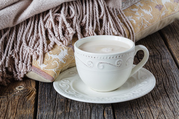 Cozy breakfast with warm plait and hot tea with milk