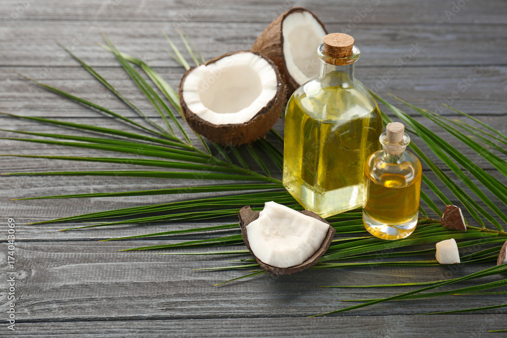 Poster Bottles with fresh coconut oil on wooden table