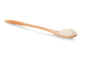 Spoon with coconut oil on white background