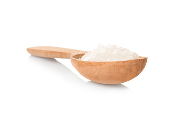 Spoon with coconut oil on white background