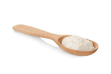Spoon with coconut oil on white background