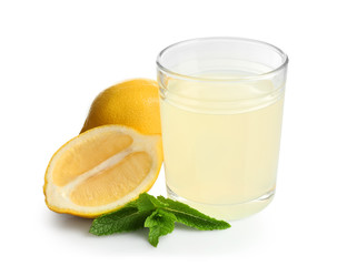 Glass of fresh lemon juice on white background