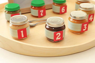 Jars with different puree on table. Game 