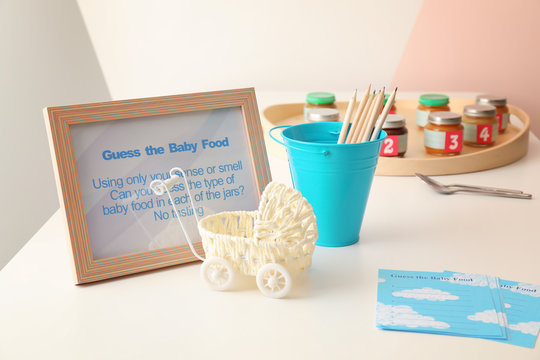 Frame with rules for game on table at baby shower party