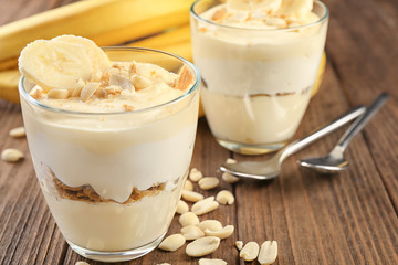 Glasses with delicious banana pudding on table