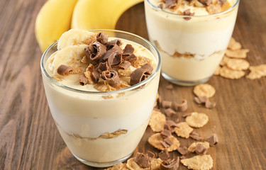 Glasses with delicious banana pudding on table
