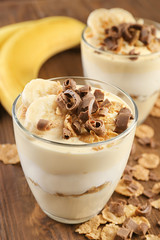 Glasses with delicious banana pudding on table