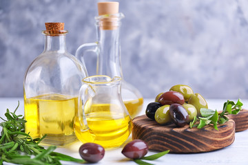 Composition with healthy olives and oil on kitchen table