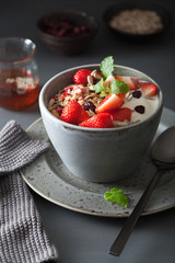 granola and yogurt with seeds and strawberry for breakfast